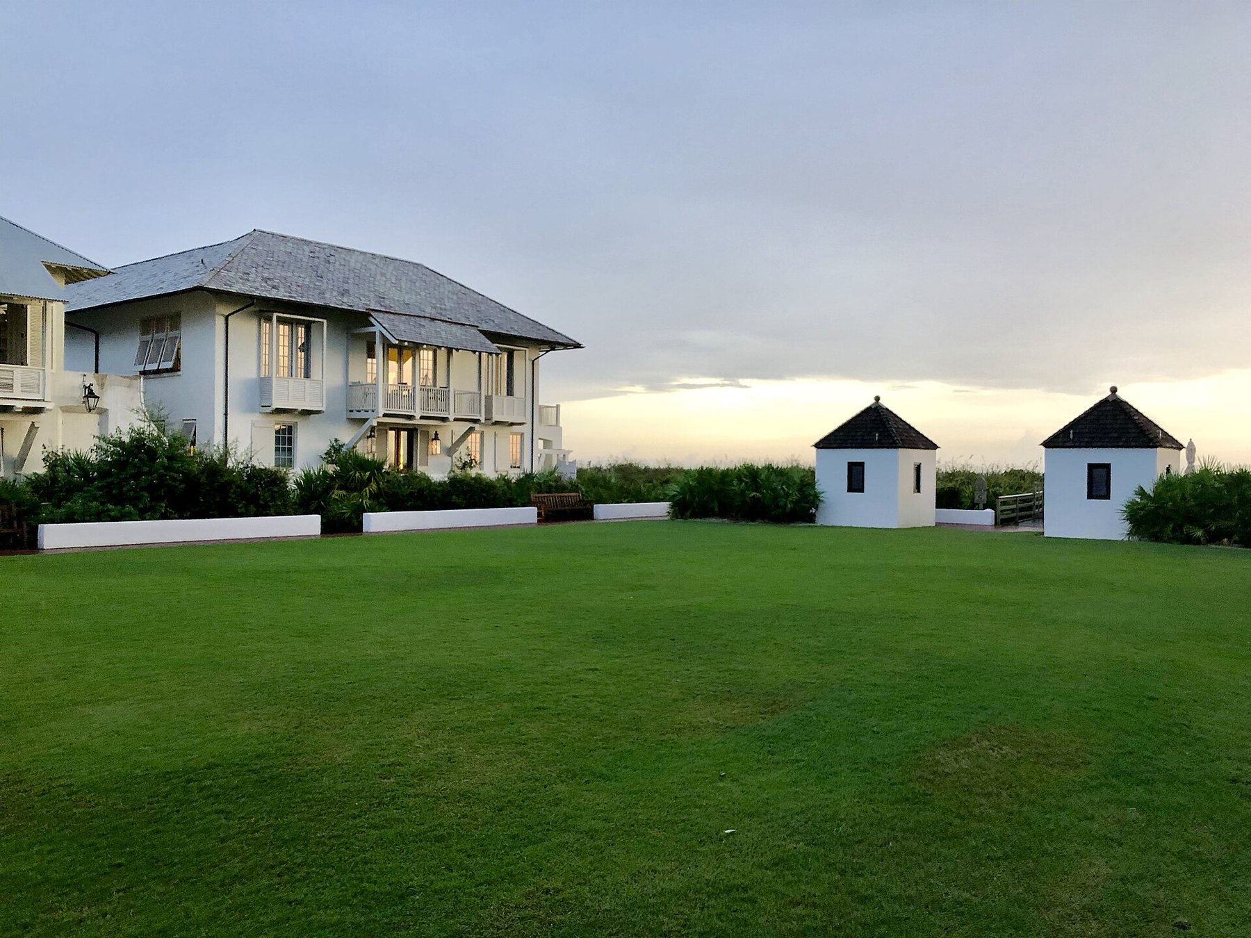 Houses beside a green lawn in the beach town of Rosemary Beach, Florida