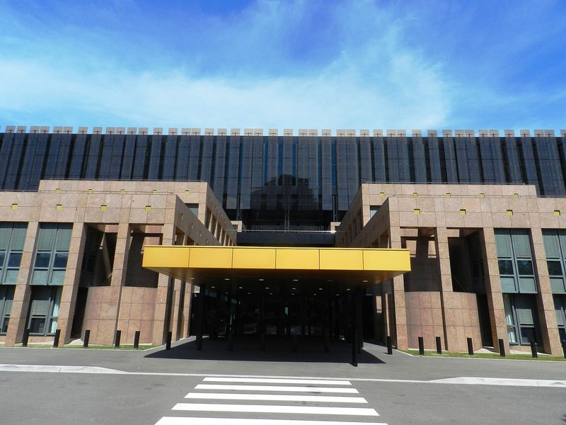 The entrance front of the Court of Justice of the European Union in Luxembourg, a dark glass upper storey above a stone-coloured base.